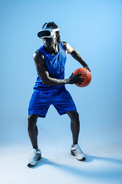 Black basketball player wearing VR headset holding ball