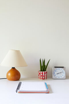 Organized home office desk with lamp and notebook