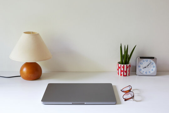 Modern home office workspace with lamp and laptop