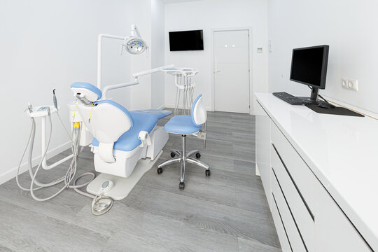 Modern dental clinic room with chair and computer setup