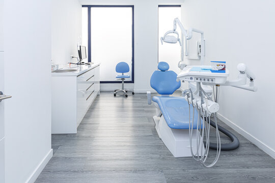 Modern dental clinic room with chair and equipment
