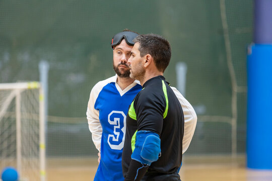Goalball players in conversation during a match