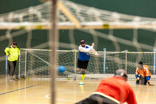 Athletes playing goalball on a court