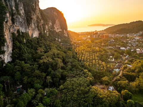 Tropical sunset over Koh Tao cliffs and coastal town