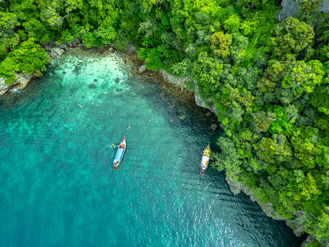 Aerial view of Koh Tao bay with longtail boats in summer