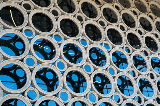 Modern facade with circular windows and reflective glass