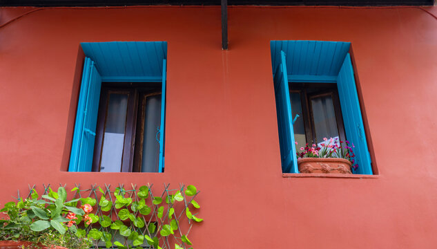 Blue shutter windows on terracotta wall in Chania, Crete