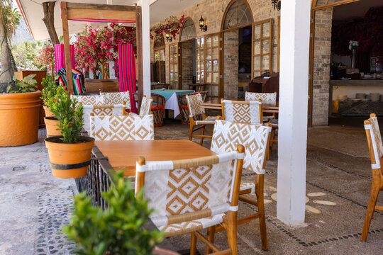 Charming Puerto Vallarta terrace with woven chairs and blooms