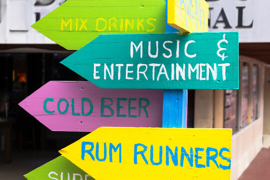 Close-up of painted wooden direction signs in Antigua