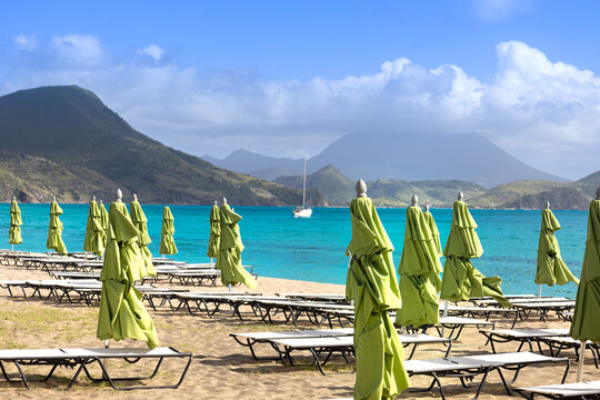 Scenic Carambola Beach with umbrellas and Nevis Peak view