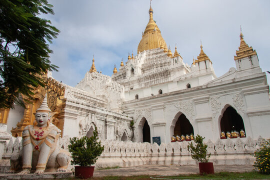 Buddhist temple in Myanmar with golden pagoda and lion