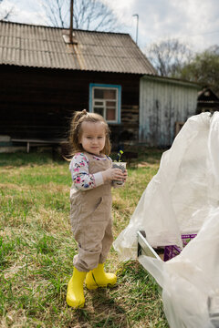 Little girl holding seedling in a garden