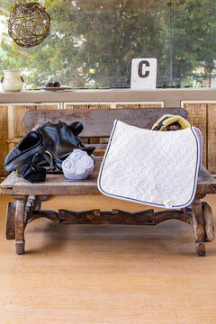 Equestrian gear set on rustic wooden bench