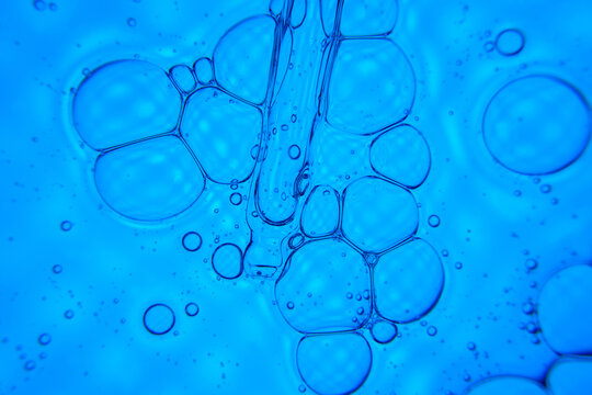 Abstract blue oil bubble texture in water macro background