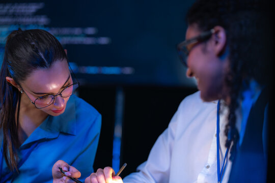Cinematic shot of a diverse, multiethnic software team talk through the screen as a trio in a modern technology office bathed in blue light, a portrait of inclusion and (frame 781)