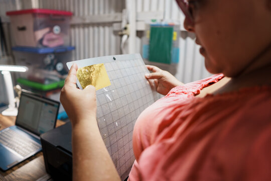Female entrepreneur creating craft designs with gold foil