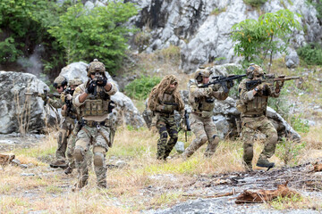 Fototapeta premium Military participate in a patrol in forrest terrain