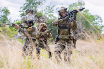 Fototapeta premium Military participate in a patrol in forrest terrain