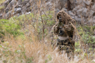 Fototapeta premium Military participate in a patrol in a rocky terrain