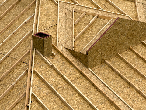 Roof framing and OSB sheathing on house under construction