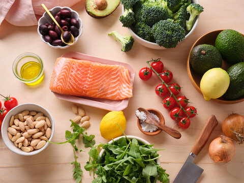 Cooking healthy meal with fresh ingredients on a wooden table at home