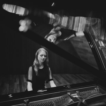 Young woman, pianist, in evening dress playing on an unfolded Steinway & Sons grand piano, black and white photo, Stuttgart, Baden-W&uuml;rttemberg, Germany