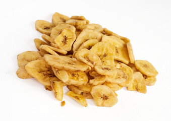 Fototapeta premium Pile of crispy dried banana chips isolated on white background 