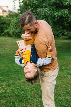 Father And Son Laughing Together Outdoors