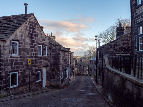 Town Gate in Heptonstall on a late November afternoon with old stone houses along the road on the village main street