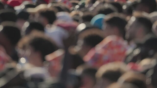 Crowd gathers at outdoor event in sunny location during afternoon hours