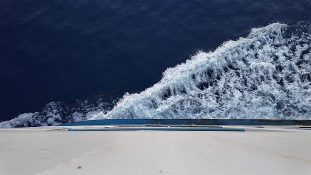 dynamic ocean wave crashing side view with blue and white foam and air bubbles in natural setting for water sports and nature scenes. High quality 4k footage