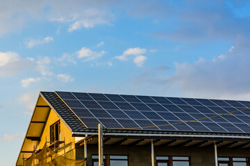 Fototapeta premium Solar panels on roof of residential house. Clean energy. Ecological concept