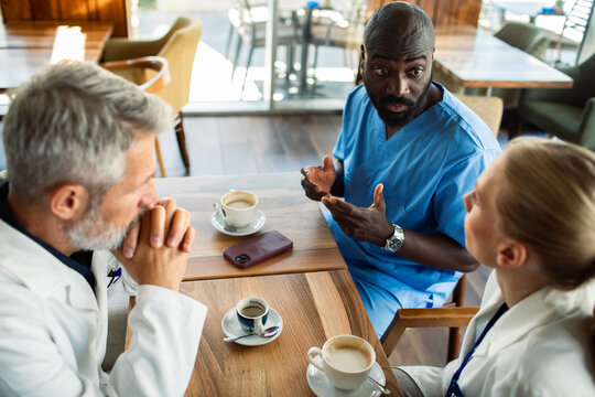 Healthcare team meeting over coffee in hospital cafeteria