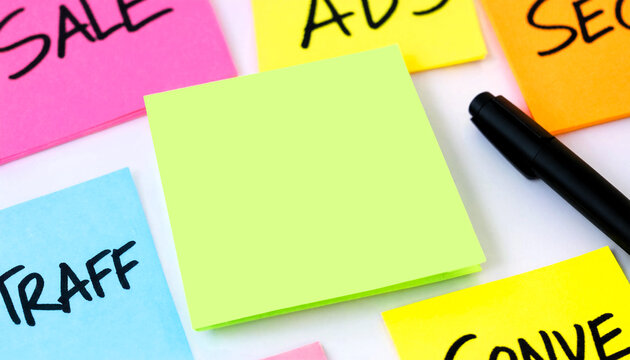 A collection of colorful sticky notes with marketing terms and a blank note