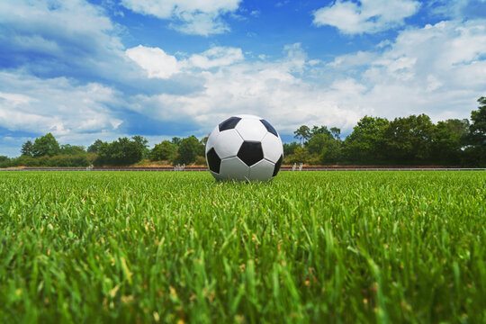 textured soccer game field with soccer ball - center, midfield