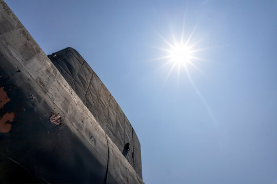 The retired HMCS Ojibwe submarine in Port Burwell, Ontario, highlighted by a clear blue sky and bright sun.