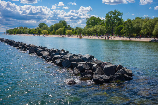 Beachgoers sunbathe on Centre Island Beach, which is located near the city of Toronto