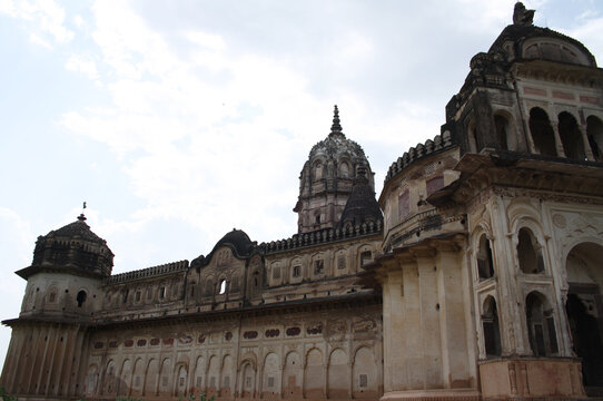 A low-angle shot highlighting the intricate stone arches, carved towers, and central spire of Lakshmi Narayan Temple in Orchh