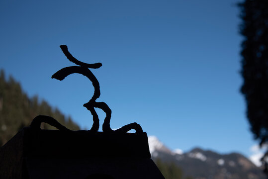 Silhouette of Om, Aum against clear blue sky in Manali, Himachal Pradesh