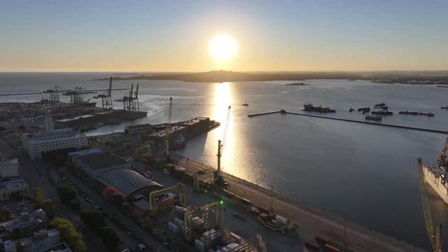Sunset Port Of Montevideo In Montevideo Maldonado Uruguay. Cargo Ship Entering Port With City Skyline In Background. Sunrise Downtown Cityscape. Illumination City. Montevideo Maldonado.