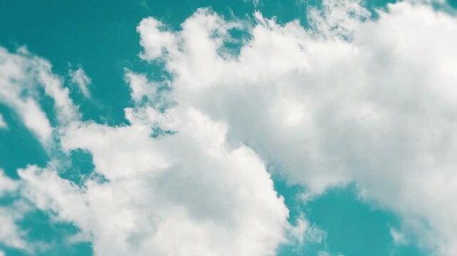 Cinematic teal color graded sky with scattered white clouds, stylized film look summer sky timelapse as a scenic background for travel lifestyle and outdoor content 16:9