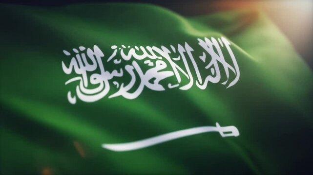 Close-up of the Saudi Arabian flag with its green fabric and white Arabic script and sword national flag