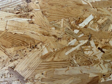 Plywood, OSB close up texture, yellowish background.