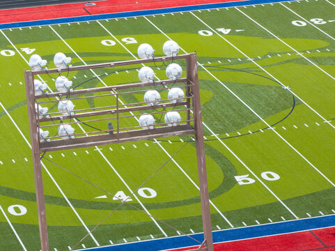 Drone shot captures wooden light tower over football field