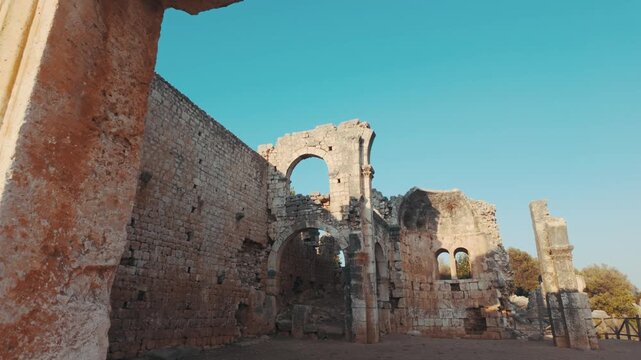 Walking inside the archaeological ruins of an ancient settlement on a sunny day.