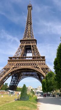 Eiffel Tower reveal from Champ de Mars in summer.