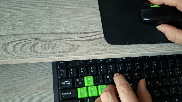  Senior person typing on keyboard and using computer mouse at ergonomic desk with copy space
