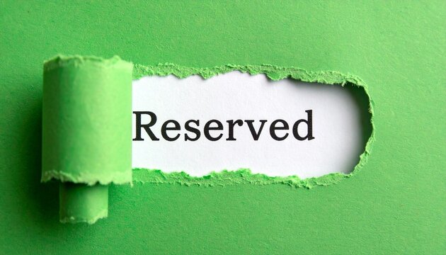 Torn green paper revealing reserved text symbolizing exclusivity and special designation