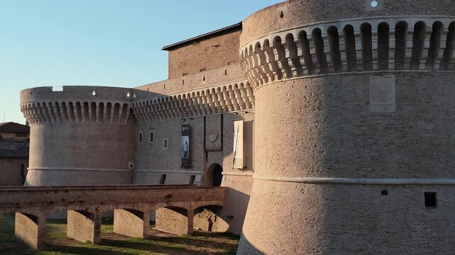 Rocca Roveresca Castle of Senigallia, Ancona with sunset lights and warm tones of summer time. Building recently cleaned in 2026. Horizontal footage panning, lateral view.