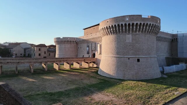 Rocca Roveresca Castle of Senigallia, Ancona with sunset lights and warm tones of summer time. Building recently cleaned in 2026. Horizontal footage panning, lateral view.